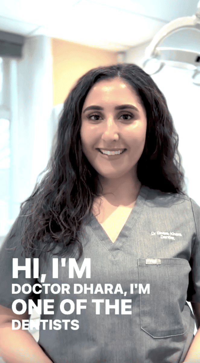 Experienced female dentist in grey uniform smiling at Hewett's Dental clinic in Brighouse, Huddersfield, Halifax, and Bradford.